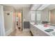 Bright bathroom featuring a long vanity with double sinks, tile flooring, and shower-tub combo at 1533 Oak Way, Sarasota, FL 34232