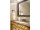 Elegant half bath with decorative mirror, vanity with marble top and bronze fixtures at 1533 Oak Way, Sarasota, FL 34232