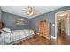 Charming bedroom features wood floors, wooden dresser, and a ceiling fan at 1533 Oak Way, Sarasota, FL 34232