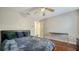 Comfortable bedroom with hardwood floors, ceiling fan, black headboard, and a modern desk at 1533 Oak Way, Sarasota, FL 34232