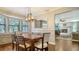Sunlit dining room adjacent to the kitchen, featuring a stylish light fixture at 1533 Oak Way, Sarasota, FL 34232