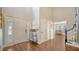 Spacious foyer with high ceilings, wood flooring, and a decorative staircase leading to the upper level at 1533 Oak Way, Sarasota, FL 34232