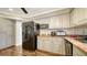 Stylish kitchen featuring stainless steel appliances and gray cabinets at 1533 Oak Way, Sarasota, FL 34232