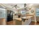 Stylish kitchen featuring stainless steel appliances, gray cabinets and a breakfast bar at 1533 Oak Way, Sarasota, FL 34232
