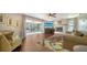 Comfortable living room with fireplace, sliding doors to lanai, and wood floors at 1533 Oak Way, Sarasota, FL 34232