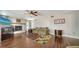 Cozy living room featuring a fireplace, ceiling fan, and colorful area rug on wood floors at 1533 Oak Way, Sarasota, FL 34232