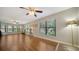 Bright living room with hardwood floors, ceiling fan, and large windows with views at 1533 Oak Way, Sarasota, FL 34232