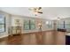 Bright living room featuring hardwood floors, multiple windows, and stylish furnishings at 1533 Oak Way, Sarasota, FL 34232