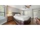 Bedroom featuring wood flooring, a ceiling fan, and closet and bathroom doors at 1533 Oak Way, Sarasota, FL 34232