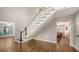 Open area showcasing staircase with black and white railings and wood floors at 1533 Oak Way, Sarasota, FL 34232