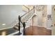 Elegant staircase with a statement lighting fixture and entry to other rooms at 1533 Oak Way, Sarasota, FL 34232