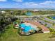 Aerial view of community featuring a large pool, clubhouse, lounge seating, and ample parking at 17108 Harvest Moon Way, Bradenton, FL 34211