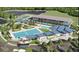Beautiful aerial view of a resort-style pool, tennis courts, clubhouse, parking and lake; perfect for recreation and relaxation at 17108 Harvest Moon Way, Bradenton, FL 34211