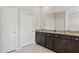 Bathroom featuring granite countertops, double sinks, large mirror and tile flooring at 17108 Harvest Moon Way, Bradenton, FL 34211