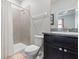 Clean bathroom featuring a shower with a white shower curtain, vanity, and tiled walls at 17108 Harvest Moon Way, Bradenton, FL 34211