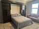 Cozy bedroom featuring a built-in murphy bed with shelving and comfortable seating at 17108 Harvest Moon Way, Bradenton, FL 34211