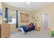 Cheerful bedroom with nautical-themed decor, enhanced by a window and matching furniture at 17108 Harvest Moon Way, Bradenton, FL 34211