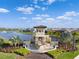 Picturesque community entrance with water feature, lush landscaping, and serene lake views at 17108 Harvest Moon Way, Bradenton, FL 34211