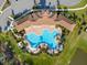 Aerial view of large community pool with ample lounge chairs and beautifully landscaped surroundings at 17108 Harvest Moon Way, Bradenton, FL 34211