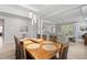 Bright dining room featuring wood table with seating for six under modern light fixture, with access to living area at 17108 Harvest Moon Way, Bradenton, FL 34211