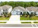 Beautiful aerial front view of the home with a three car garage, manicured lawn and landscaping at 17108 Harvest Moon Way, Bradenton, FL 34211