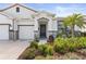 Inviting front entrance with stone accents, a well-maintained yard, and colorful landscaping at 17108 Harvest Moon Way, Bradenton, FL 34211