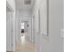 Hallway showing neutral paint and tile flooring, with access to various rooms at 17108 Harvest Moon Way, Bradenton, FL 34211