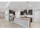 Spacious kitchen featuring stainless steel appliances, an island with bar seating, and modern cabinetry at 17108 Harvest Moon Way, Bradenton, FL 34211