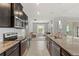 Modern kitchen with stainless steel appliances, dark cabinets, granite countertops, and a subway tile backsplash at 17108 Harvest Moon Way, Bradenton, FL 34211