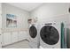 Bright laundry room with white cabinets, modern washer and dryer, and stylish decor at 17108 Harvest Moon Way, Bradenton, FL 34211