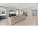 Open-concept living room with modern decor, large windows, and an adjacent dining area for seamless entertaining at 17108 Harvest Moon Way, Bradenton, FL 34211