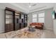 Comfortable living room featuring custom built-in shelving, ample natural light, and neutral tones at 17108 Harvest Moon Way, Bradenton, FL 34211