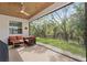 Relaxing screened porch with comfortable seating and view of lush backyard at 17108 Harvest Moon Way, Bradenton, FL 34211