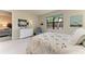 Bright bedroom with a cozy quilt, neutral colors, and a large window offering plenty of natural light at 17696 Northwood Pl, Lakewood Ranch, FL 34202
