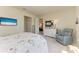 Bright bedroom featuring a TV, white dresser, and blue chair at 17696 Northwood Pl, Lakewood Ranch, FL 34202