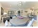 Open-concept dining area adjacent to the living room, with a modern chandelier and easy access to the kitchen at 17696 Northwood Pl, Lakewood Ranch, FL 34202
