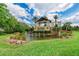 Picturesque Del Webb Lakewood Ranch entrance with water feature, lush landscaping, and welcoming signage at 17696 Northwood Pl, Lakewood Ranch, FL 34202