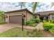 Beautiful home with a well-manicured lawn, complemented by a brick driveway and two-car garage at 17696 Northwood Pl, Lakewood Ranch, FL 34202