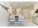 Kitchen bar with seating, pendant lights, and modern decor that adds a clean and airy touch at 17696 Northwood Pl, Lakewood Ranch, FL 34202