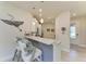 Bright kitchen featuring bar seating, pendant lighting, and neutral countertops at 17696 Northwood Pl, Lakewood Ranch, FL 34202