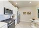 Modern kitchen featuring stainless steel appliances, white cabinets, and a cozy breakfast nook at 17696 Northwood Pl, Lakewood Ranch, FL 34202