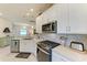Well-equipped kitchen with modern appliances, white cabinets, and a stylish backsplash at 17696 Northwood Pl, Lakewood Ranch, FL 34202