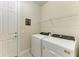 Well-lit laundry room equipped with modern washer and dryer units at 17696 Northwood Pl, Lakewood Ranch, FL 34202