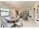 Spacious living and dining area featuring tile floors, neutral decor, and ample natural light at 17696 Northwood Pl, Lakewood Ranch, FL 34202