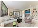 Cozy living room featuring comfortable sofas, stylish decor, and sliding glass doors to the outdoor patio at 17696 Northwood Pl, Lakewood Ranch, FL 34202