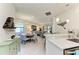 Open-concept living space with modern decor, bright lighting, and a seamless flow into the dining area at 17696 Northwood Pl, Lakewood Ranch, FL 34202