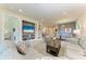 Spacious living room with neutral tones, built-in shelving, and an open concept design to the dining area at 17696 Northwood Pl, Lakewood Ranch, FL 34202