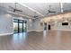 Spacious meeting room with gray walls, wood floors, and ample natural light for gatherings and events at 17696 Northwood Pl, Lakewood Ranch, FL 34202