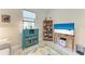 Well-lit office space with desk and colorful decorations on shelf at 17696 Northwood Pl, Lakewood Ranch, FL 34202