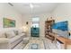 Bright office featuring neutral walls, sofa, desk with TV and lots of light at 17696 Northwood Pl, Lakewood Ranch, FL 34202